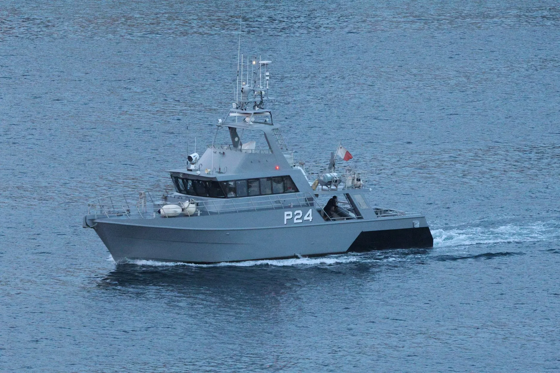 A military patrol boat under way in open water.