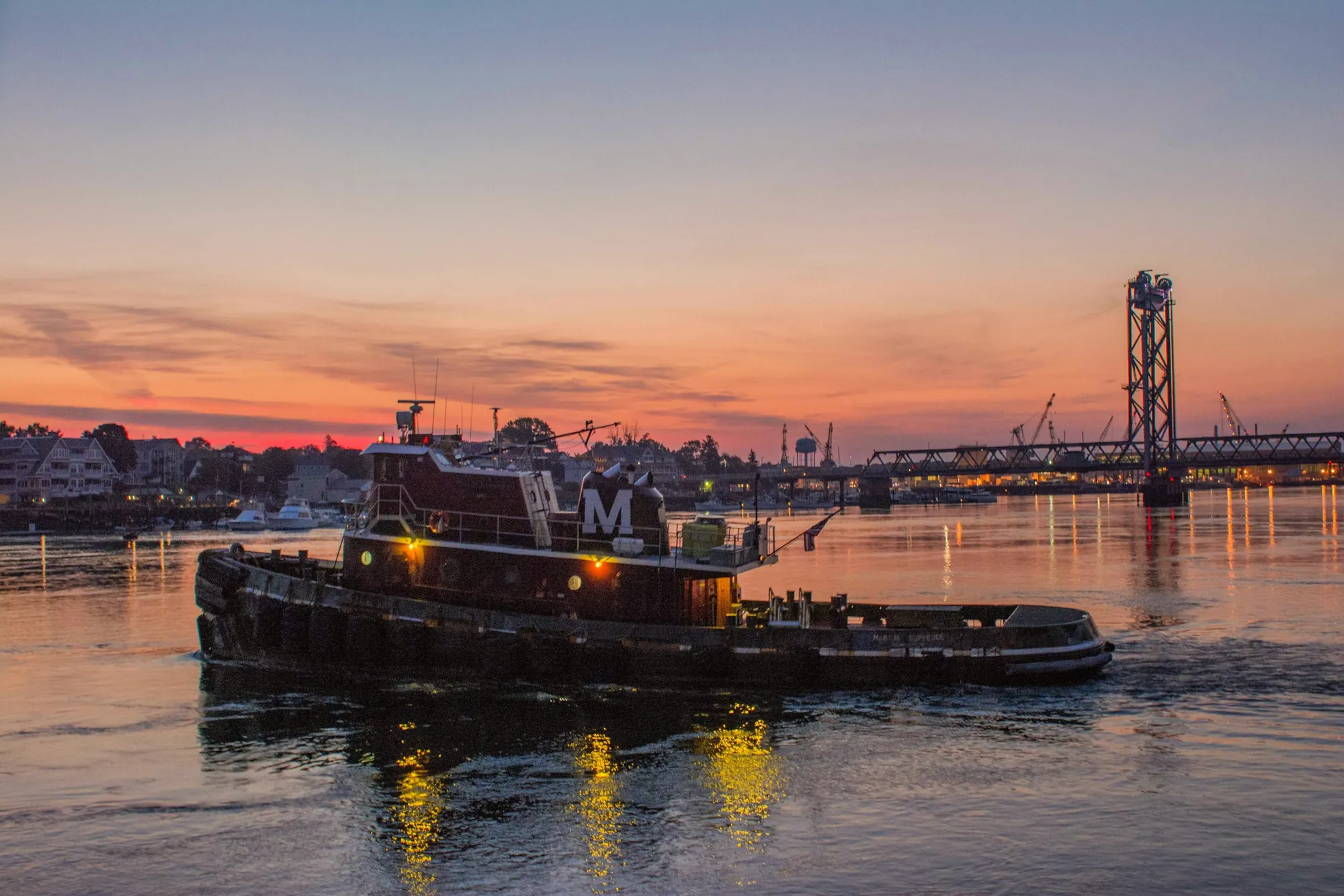 A harbour tug under way at first light.