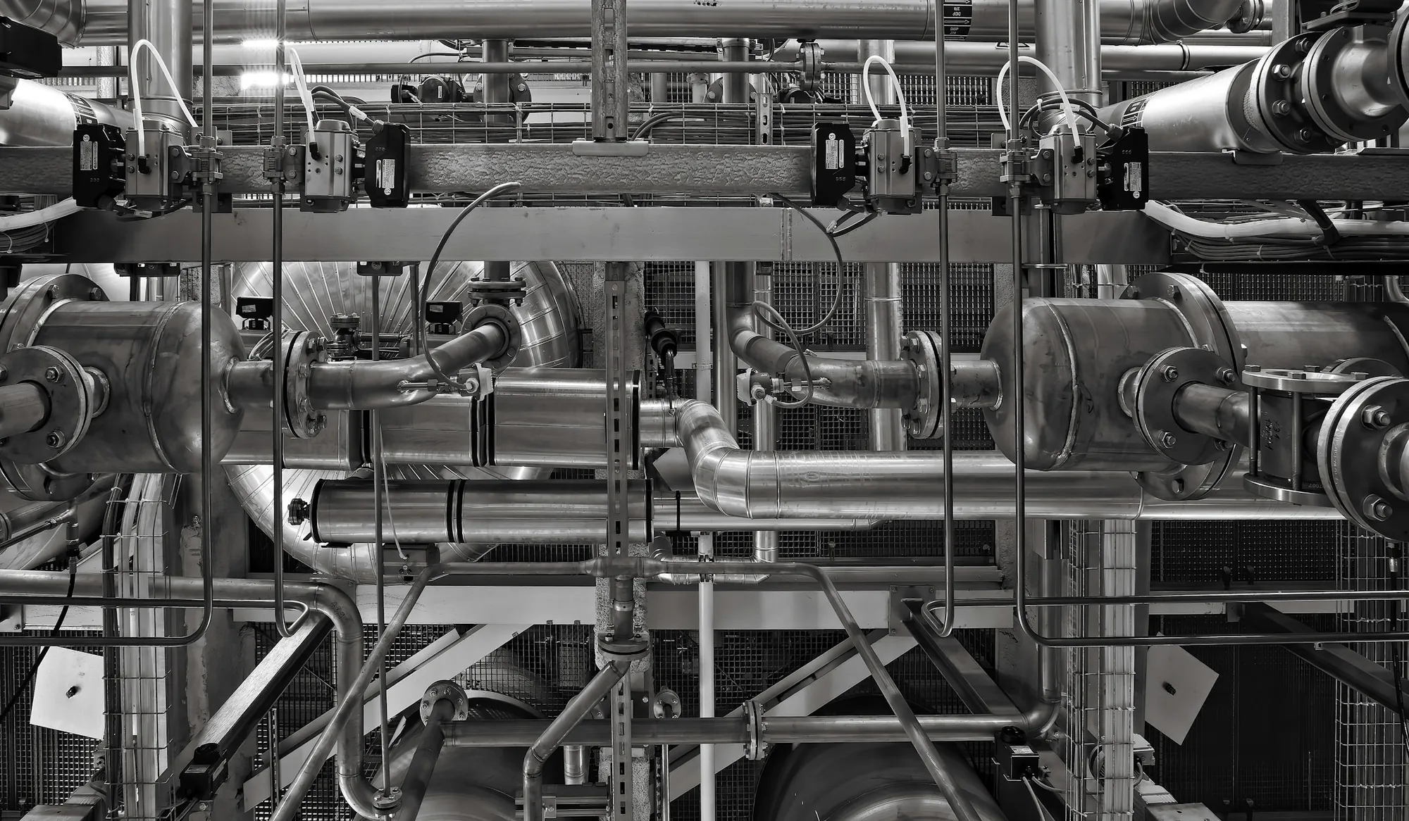 Process pipework and valves running through an industrial plant.