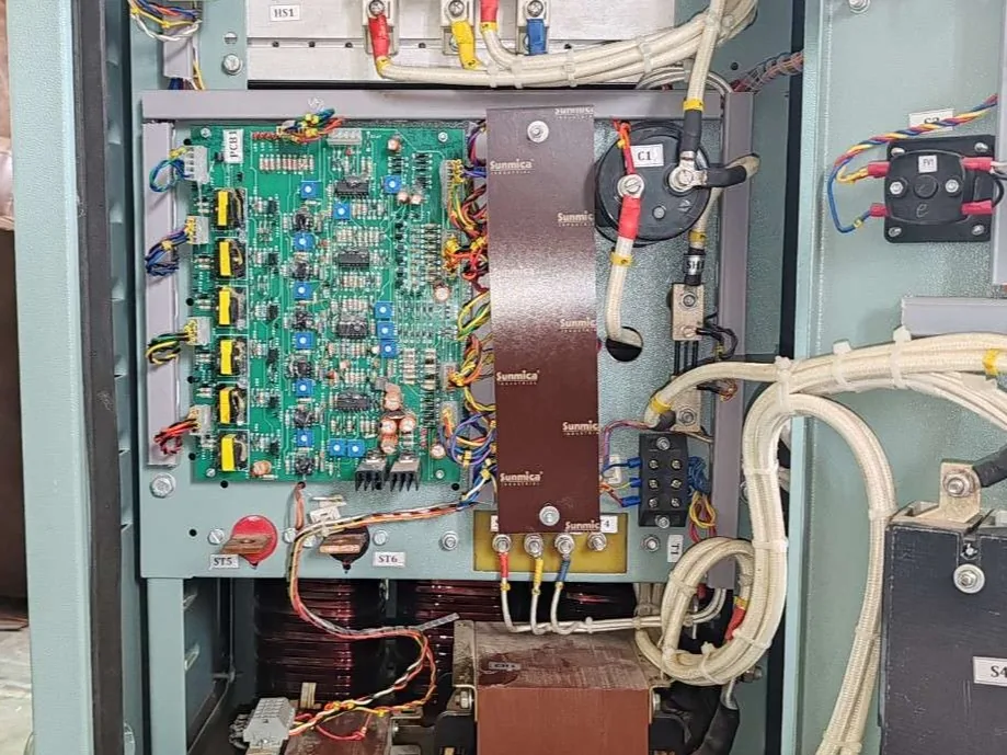 The control board of a rectifier, gate drive transformers beside it and wiring looms dressed away to the terminal blocks.