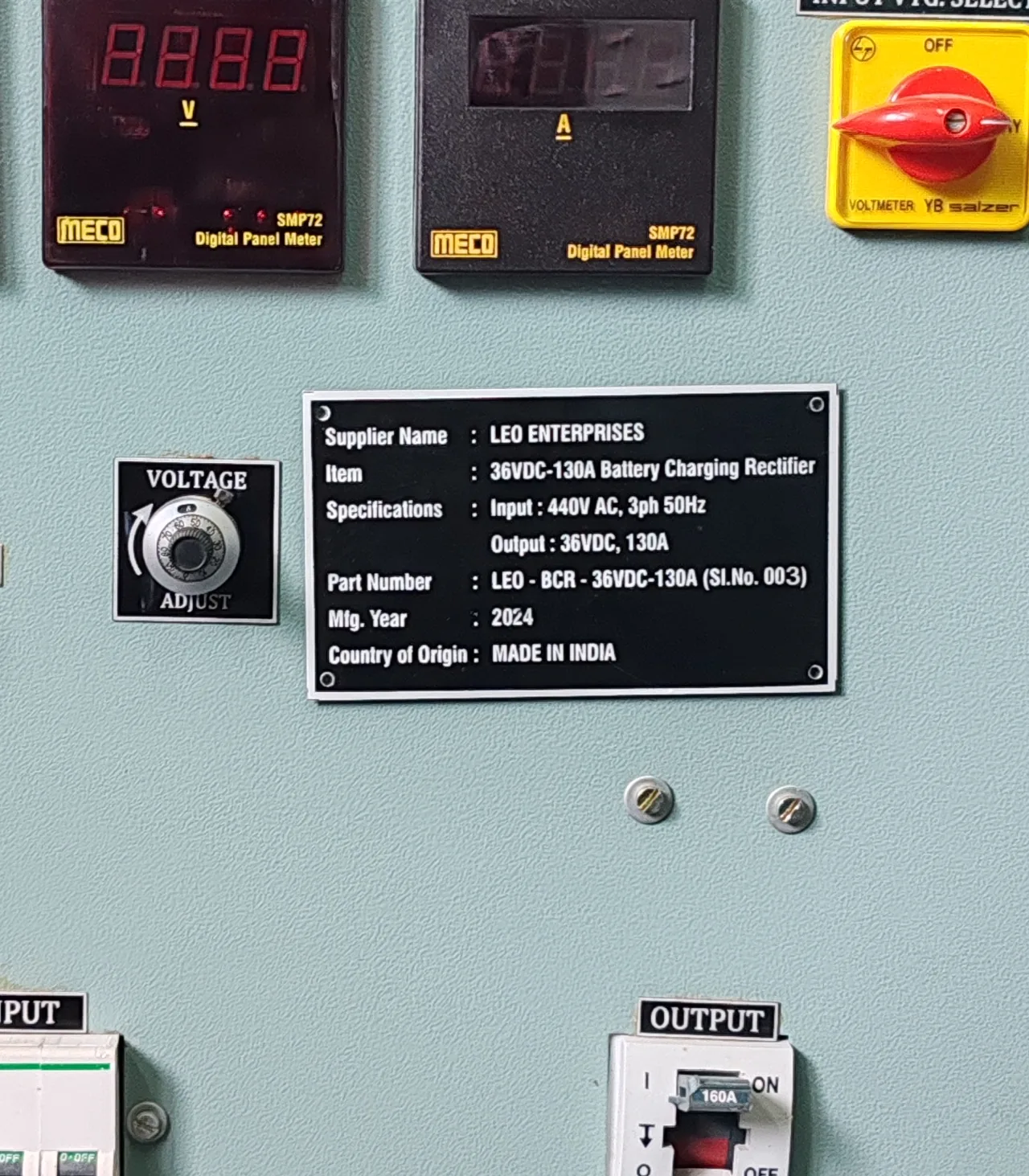 The equipment nameplate: Leo Enterprises, 36VDC-130A battery charging rectifier, input 440V AC three phase 50 Hz, output 36V DC 130A, part number LEO-BCR-36VDC-130A, 2024, made in India.